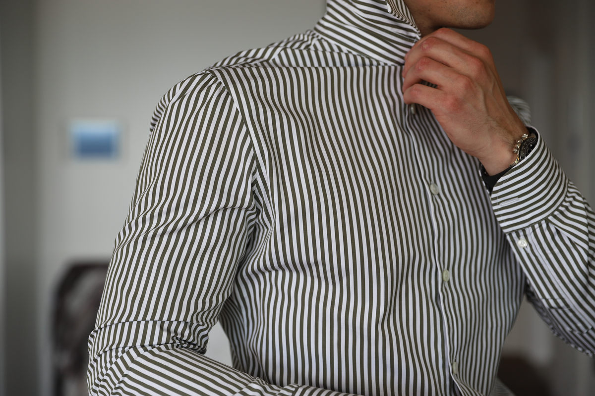 Man buttons his striped Amarcord shirt
